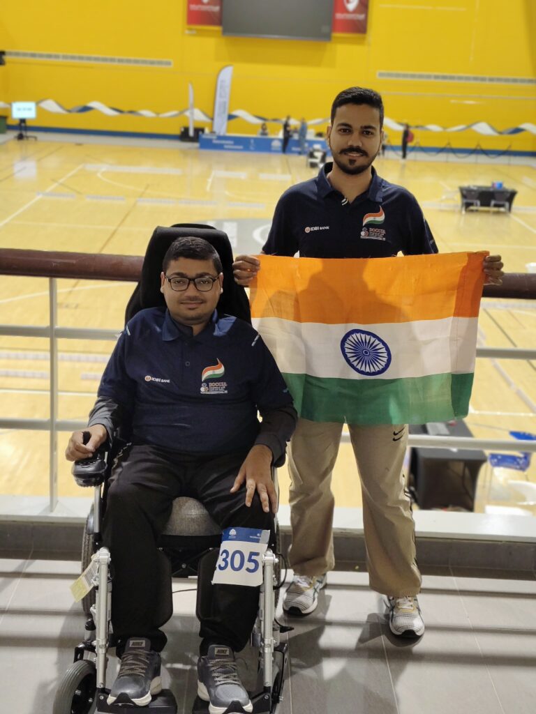 Ashok Kumar holding Indian flag after international Boccia match